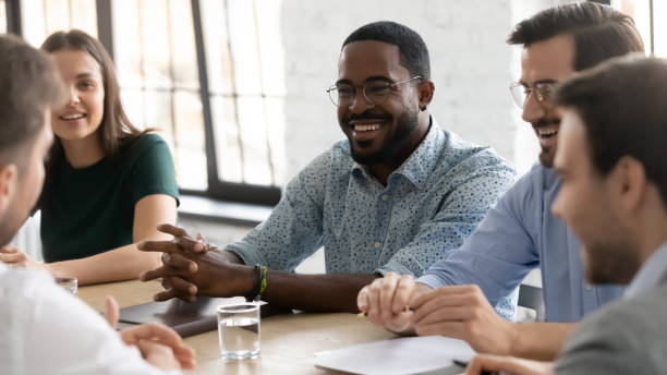 istock Smiling multiethnic coworkers brainstorm discussing ideas in office 1219224603
