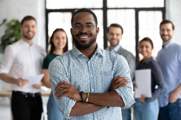 istock Smiling African American posing with colleagues in office 1219224625