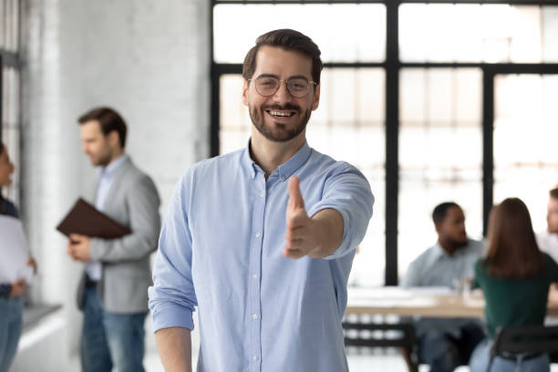 istock Happy male boss stretch hand meeting newcomer at workplace 1219224635