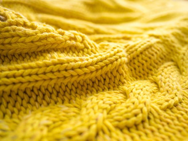 istock Close-up of yellow fabric with knitting pattern 1219224725