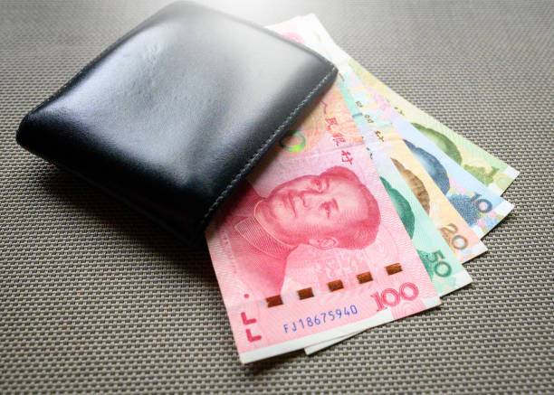 istock Chinese Yuan in a wallet on textured background 1219226158