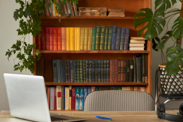 istock Workplace with notebook laptop in the home library, quarantined work from home, remote work 1219227340