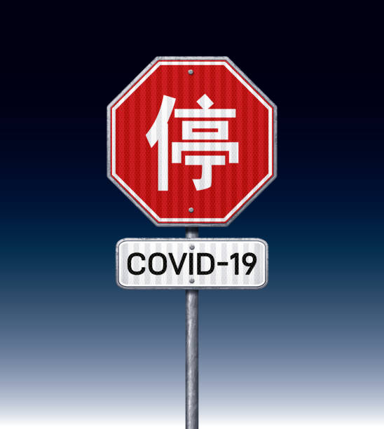 istock COVID-19 placard with Chinese stop traffic sign 1219227515