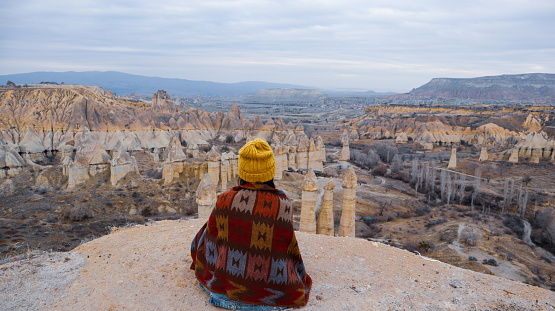 Woman watching the volcanic landscape at the valley of love in Goreme, Cappadocia