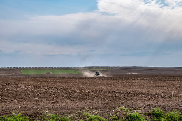 istock Tractor ploughing field in early spring 1219237787