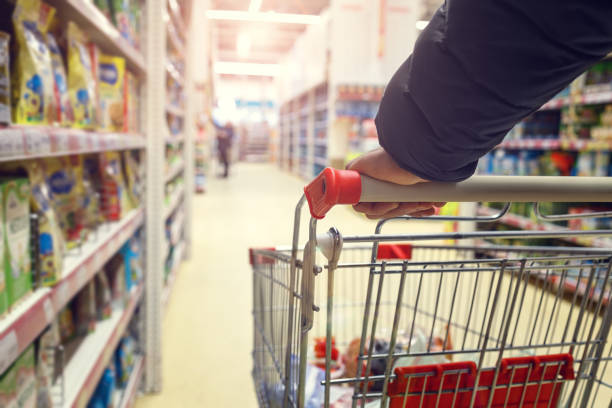 istock Man with a basket walks in a supermarket. 1219239264