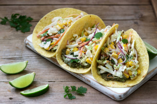 istock Vegetarian tacos stuffed with cabbage salad on a wooden background. Rustic style. 1219241885