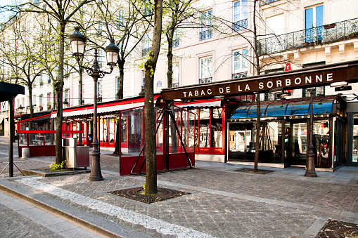 Paris, Sorbonne place : Terrace and coffee shop are closed and empty during pandemic Covid 19 in Europe. Sorbonne square, usually crowded and alive is empty. There are no people and no cars because people must stay at home and be confine. Schools, restaurants, stores, museums... are closed. Paris, in France. March 30, 2020