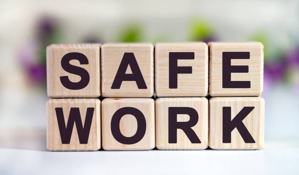 istock SAFE WORK - text on wooden cubes on a floral background with tulip buds 1219242064