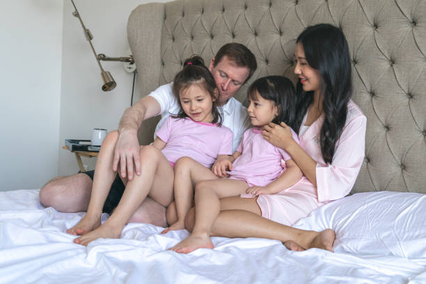 istock Family Snuggling in Bed 1219244038