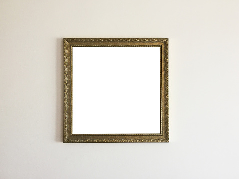 Empty picture frame (clipping path) hanging on wall