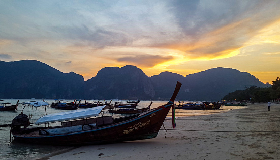 In March 2016, longtail boats drivers were waiting for tourists at Koh Phi Phi at sunset to bring them back to their hotel, Thailand