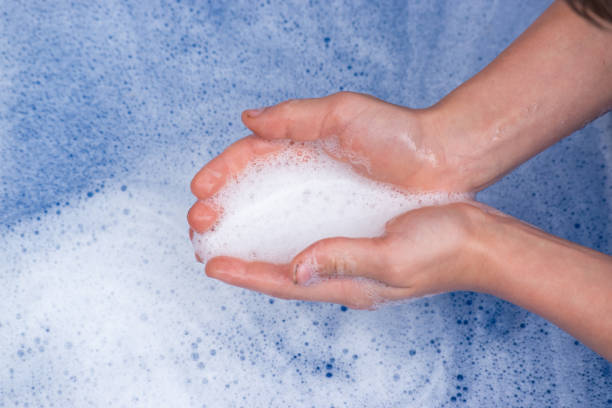 istock closeup of cupped hands with soap bubbles over soapy water 1219247030