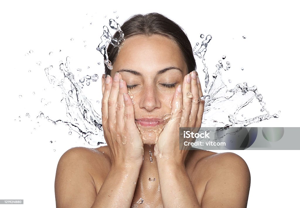 Beautiful wet woman face with water drop Beautiful wet woman face with water drop. Close-up portrait on white background Washing Face Stock Photo