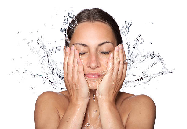 Beautiful wet woman face with water drop Beautiful wet woman face with water drop. Close-up portrait on white background woman washing face stock pictures, royalty-free photos & images