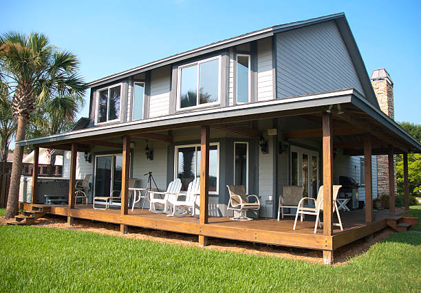 istock Modern Home With Wraparound Wooden Porch 121925156