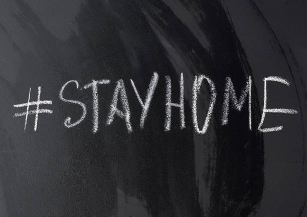 istock inscription stay home in chalk with a hashtag on a black chalk board 1219251614