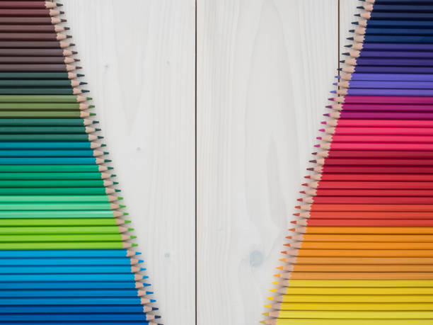istock two rows of colored pencils on wooden background 1219255409