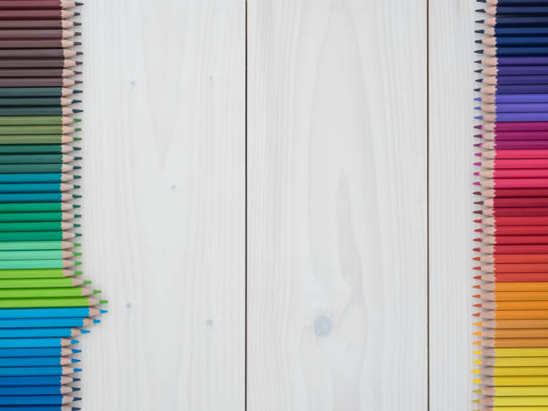 istock two rows of colored pencils on wooden background 1219255419