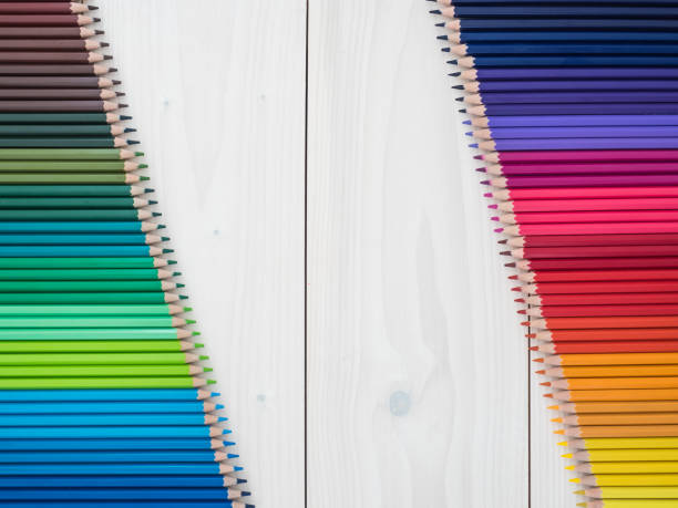 istock two rows of colored pencils on wooden background 1219255431