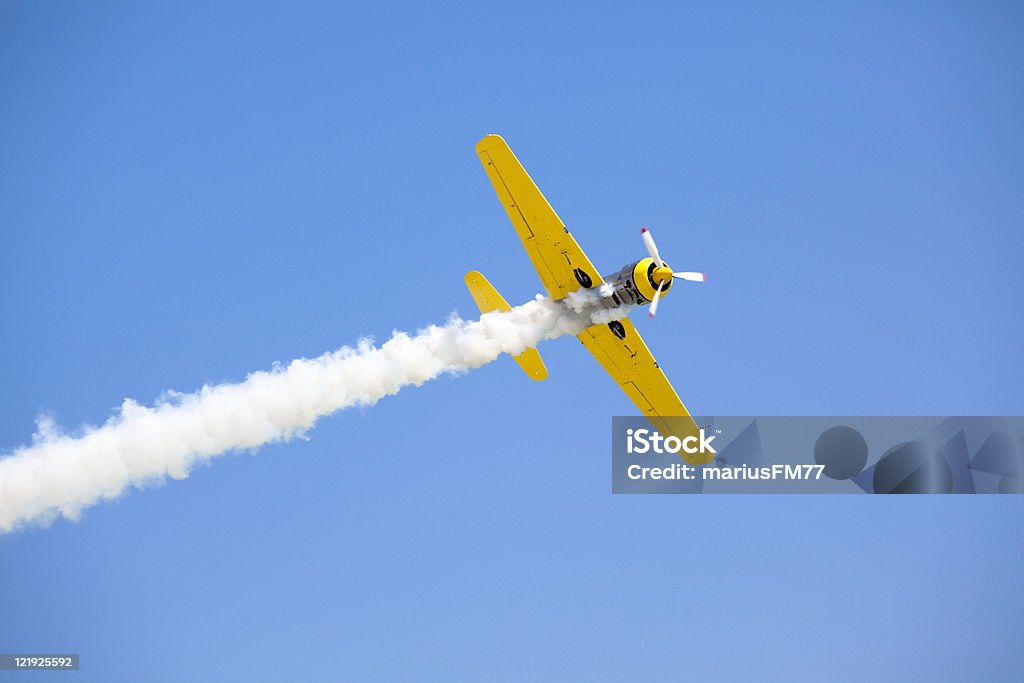 Old fashioned bright yellow propeller plane in sky Old Propeller Airplane Airshow Stock Photo