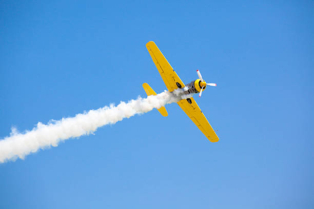 Old fashioned bright yellow propeller plane in sky Old Propeller Airplane airshow photos stock pictures, royalty-free photos & images
