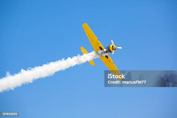 Old Fashioned Bright Yellow Propeller Plane In Sky Stock Photo - Download Image Now - Airshow, Airplane, Smoke - Physical Structure