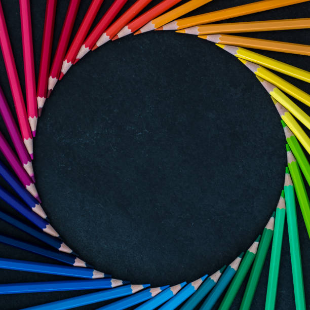 istock Set of colored pencils arranged in a wheel on slate background 1219256077