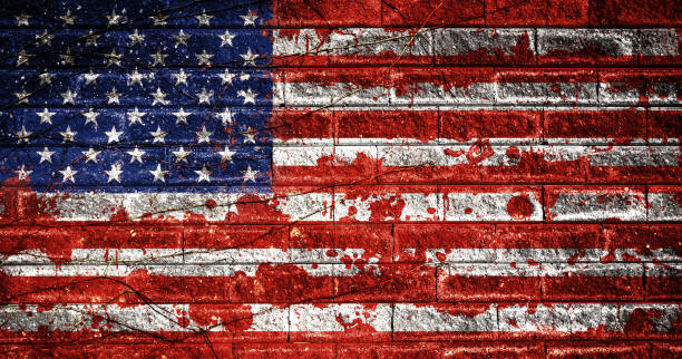 American flag with blood stains on a brick wall. USA national flag with blood splatters. Old retro grunge vintage style texture. Large image. stock photo