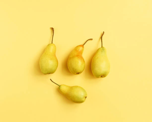 istock Yellow pear on a yellow background. Pear home decor. Yellow decorative pear 1219261184
