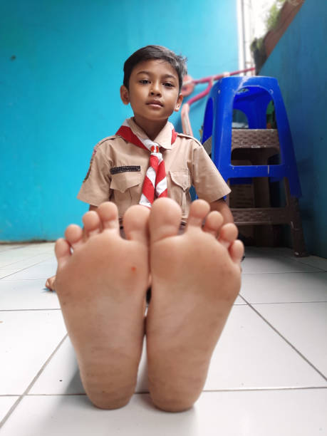 This young Asian boy is wearing his Scout Uniform as he lets us grab a few snapshots of him during recess at his school.