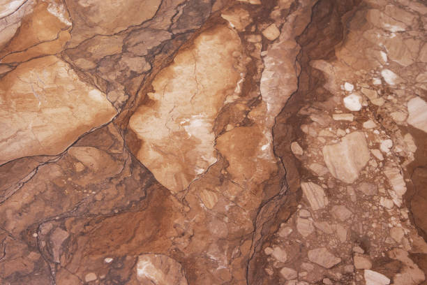 Gold marbling texture design. Beige and golden marble pattern. Fluid art. Wall texture with cracks beige marble background. Background. Abstract agate polished. It can be used for interior-exterior home decoration and ceramic tile surface, Wallpaper.