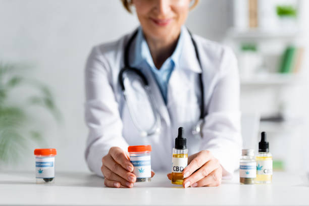 cropped view of doctor in white coat holding bottles with cbd and medical cannabis lettering cropped view of doctor in white coat holding bottles with cbd and medical cannabis lettering medical cannabis stock pictures, royalty-free photos & images