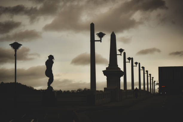 An image of a bridge silhouetted against an overcast sky.