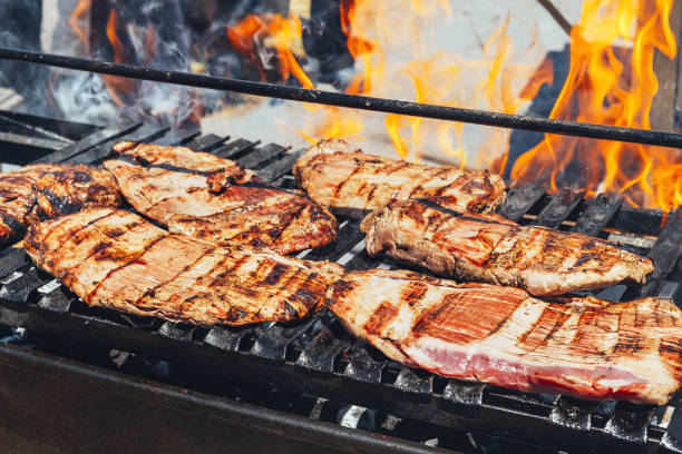 istock barbecue steaks cooking on a flaming grill 1219263707