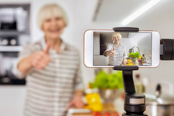 istock Retirement woman using modern smartphone, recording video blog 1219263797