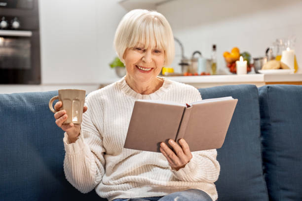 istock Retirement woman spending weekend at home, reading book 1219263807