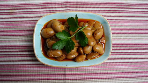 Kidney bean & bean grain appetizer in appetizer plate on striped tablecloth and parsley on it