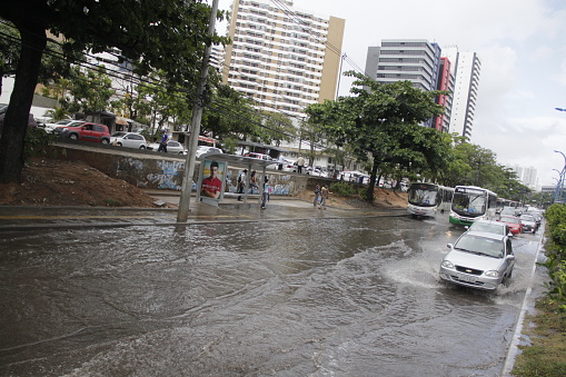 salvador, bahia / brazil - december 11, 2014: Vehicles are seen flooding due to heavy rain in the neighborhood of Pituba in the city of Salvador.