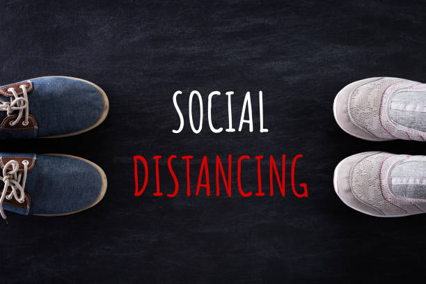 istock Social Distancing concept. shoes with ruler on blackboard by far from other by using social distancing concept to stop the coronavirus from spreading. 1219270672