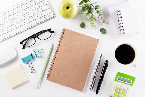istock Flat lay, top view office table desk. Workspace with keyboard, office supplies, pencil, green leaf, and coffee cup with copy space on white background. 1219270679