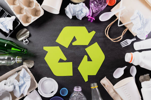 istock Top view of Different garbage materials with recycling symbol on black background. Recycle, World Environment Day, go green and Eco concept 1219270692