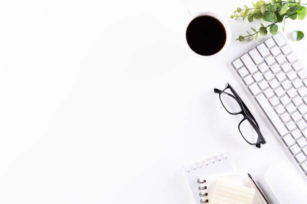 istock Flat lay, top view office table desk. Workspace with keyboard, office supplies, green leaf, and coffee cup with copy space on white background. 1219270736
