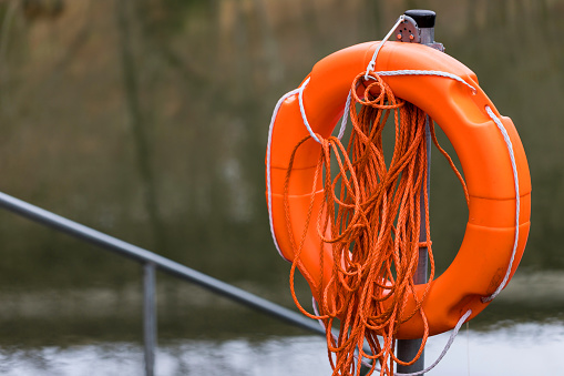 orange lifebuoy on a lake
