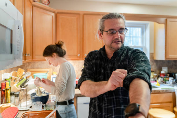 istock Father rolling up his sleeves to help his daughter cook. 1219273044