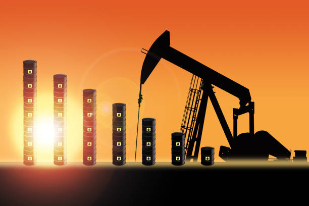 Sunset Over Pumpjack Silhouette and Oil Barrel Chart Rows of oil barrel drums decreasing in bar chart format with pump jack silhouette against a sunset sky with deliberate lens flare and copy space. Concept of decreasing oil production output or falling oil prices. oil pump oil industry alberta equipment stock pictures, royalty-free photos & images