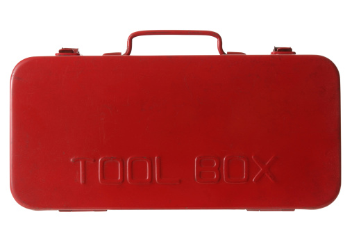 Closed bright red metal toolbox on white background with clipping path.