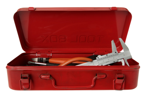 Wide angle view of opened red toolbox with tools inside isolated on white background with CLIPPING PATH.