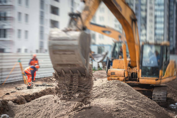 istock Yellow heavy excavator excavating sand and working during road works, unloading sand during construction of the new road 1219286896