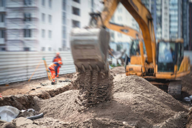 istock Yellow heavy excavator excavating sand and working during road works, unloading sand during construction of the new road 1219286902